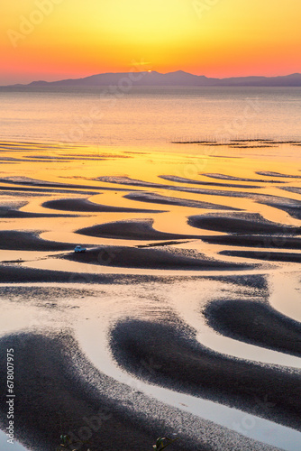 Sand pattern of Mikoshirai Coast, the sea, and the setting sun , Japan,Kumamoto prefecture,Uto-shi,Toguchi Town March 2017 photo