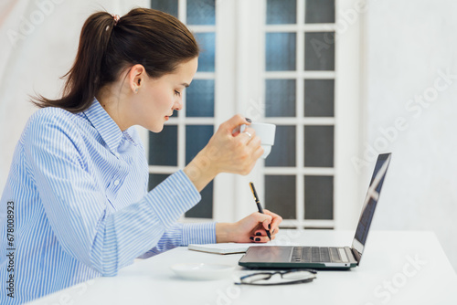 Business woman secretary in office working online on computer © dmitriisimakov