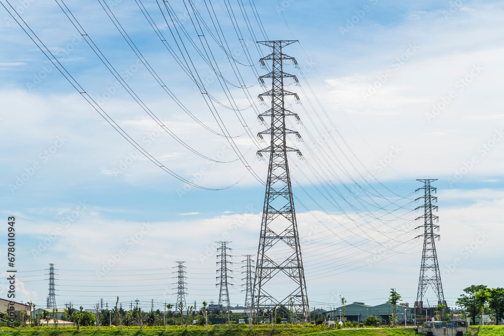 Close-up of high voltage tower and electric line with the sky background.
