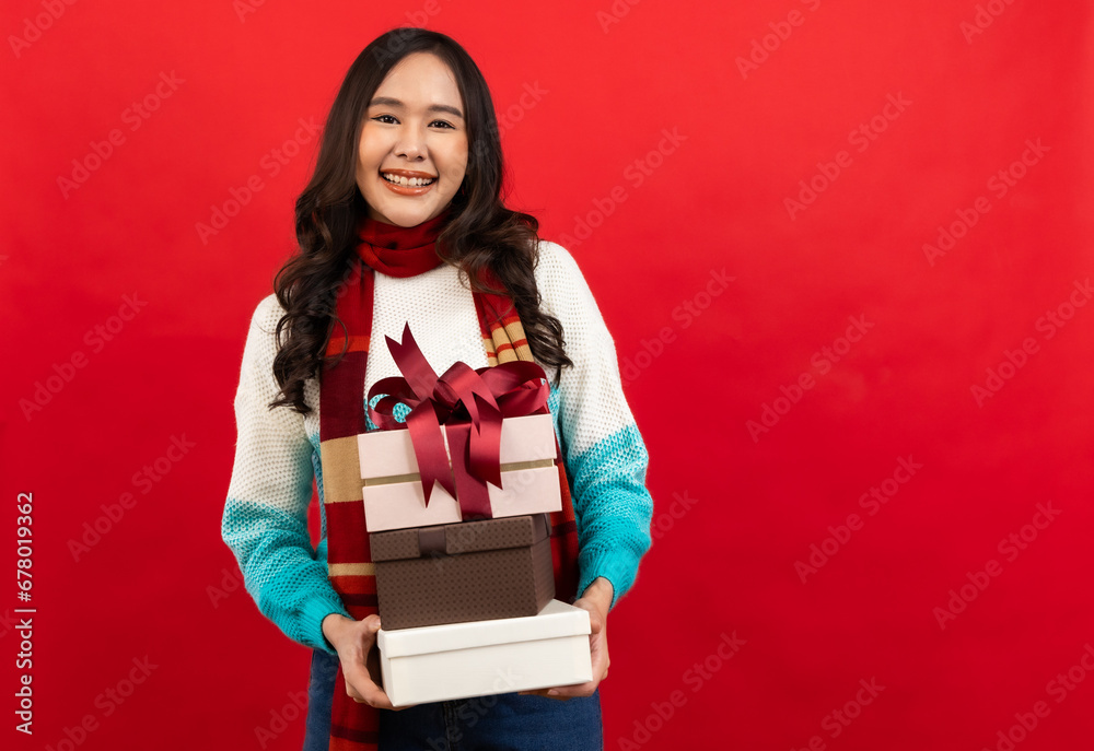 ..Happy smiling asian woman holding gift box over red ..Happy smiling asian woman holding gift box over red background... ..Happy smiling asian woman holding gift box over red ..Happy smiling asian woman holding gift box over red background...
