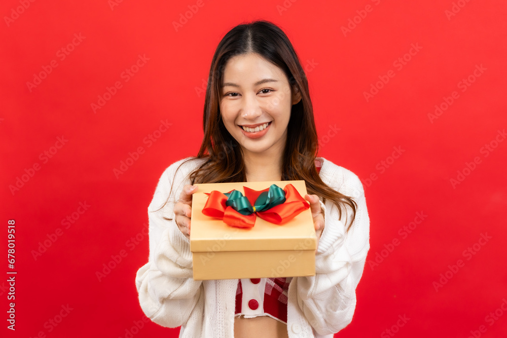 ..Happy smiling asian woman holding gift box over red ..Happy smiling asian woman holding gift box over red background... ..Happy smiling asian woman holding gift box over red ..Happy smiling asian woman holding gift box over red background...
