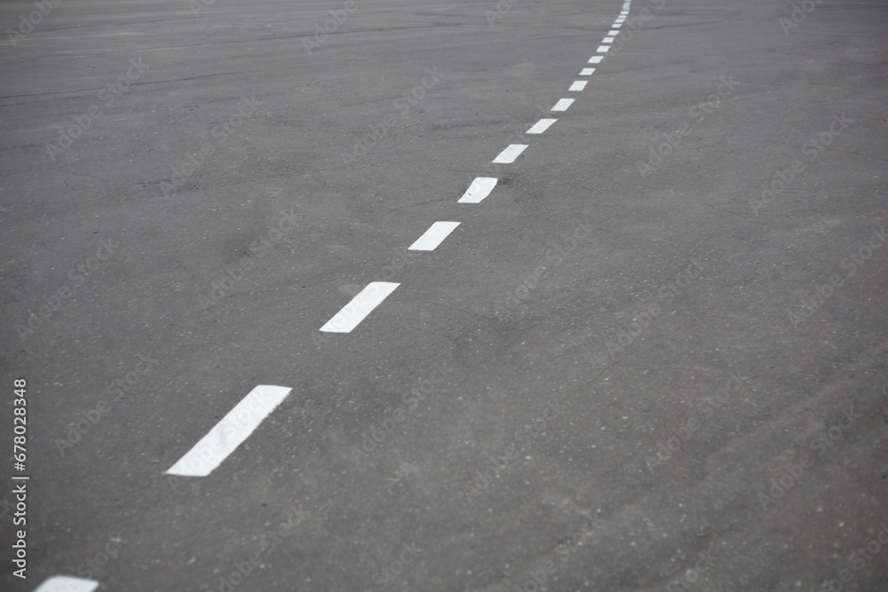 Bike path. Markings on the road. Broken white line on asphalt. Bike path. Markings on the road. Broken white line on asphalt.
