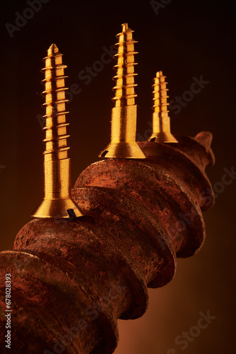 Canvas Print New brass screws juxtaposed with oversized rusty one