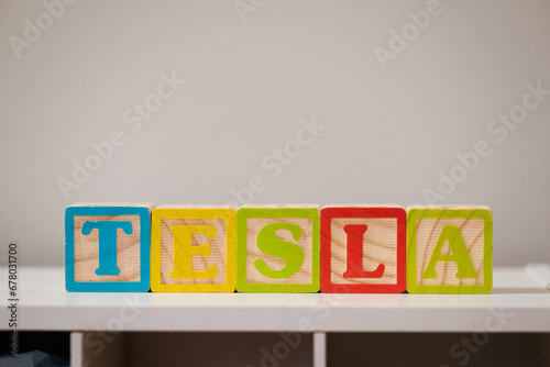 TESLA Stock symbol/ ticker made with kids wooden block.: Stock exchange ticker wooden blocks concepts