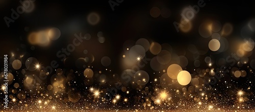 Festive background with golden particles on dark surface Abstract holiday backdrop Copy space image Place for adding text or design photo