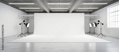 Empty photo studio with white cyclorama and various softbox monoblock flashes Copy space image Place for adding text or design