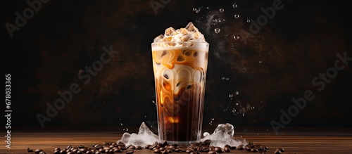 Cream is poured over iced coffee in a tall glass Copy space image Place for adding text or design photo