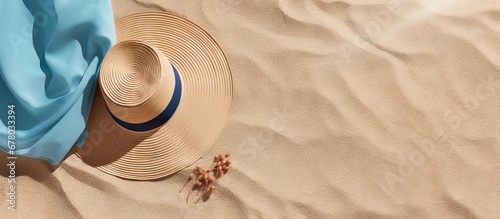 Female sunglasses straw hat and beach towel arranged on beach sand Minimalistic lifestyle fashion content for blogs magazines and social media Enjoy sunbathing and relaxing during summer travel photo