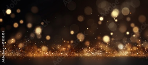 Festive background with golden particles on dark surface Abstract holiday backdrop Copy space image Place for adding text or design photo