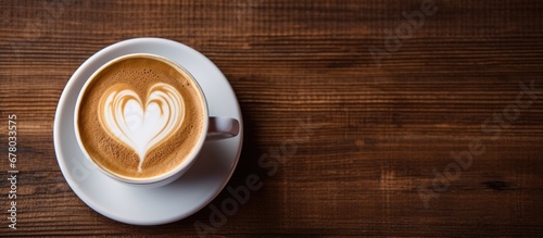 Coffee poured in heart shape on wooden table Copy space image Place for adding text or design