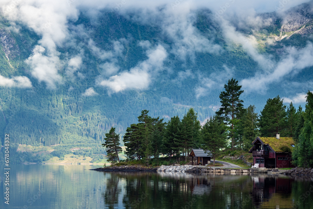 Clouds and mountains reflecting on fjord in Norway Clouds and mountains reflecting on fjord in Norway