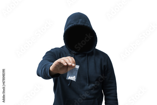 Faceless man in a hood holds transparent plastic bag with white pills hard drugs on transparent background, anonymous drug dealer or gangster sells narcotics photo