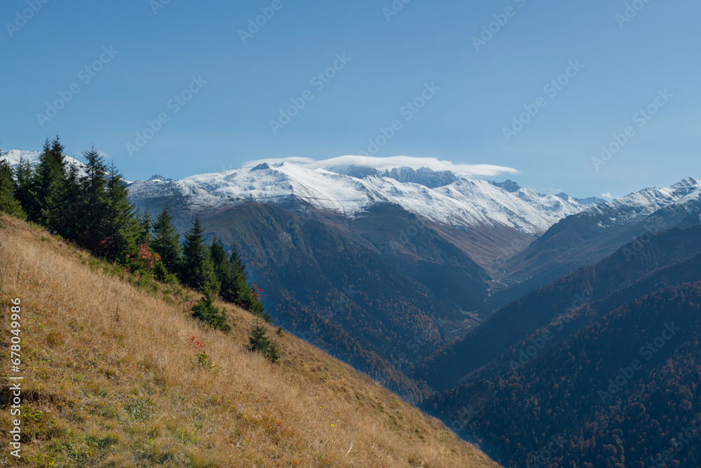 Foggy and snowy mountain landscape. Mountains covered with fog and clouds. Snow-capped hills. Snow-covered forest landscape. Black Sea mountains. Pokut Plateau. Kackar Mountains. Rize, Türkiye.