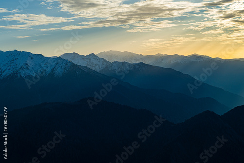 Snowy mountains and white clouds in the blue sky. Snowy mountain view from Huser Plateau. Rize, Türkiye.