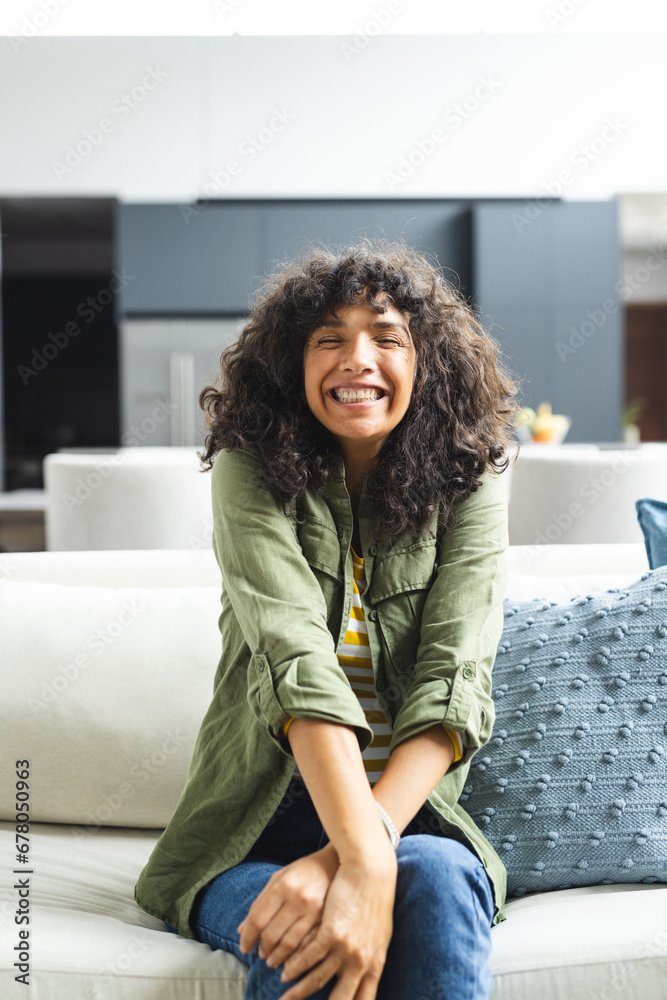 Happy caucasian woman having video call, smiling on couch in sunny living room, copy space Happy caucasian woman having video call, smiling on couch in sunny living room, copy space