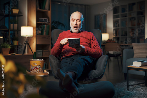 Happy senior man using a digital tablet © StockPhotoPro