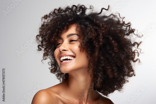 Portrait of a cheerful young black woman with curly hair