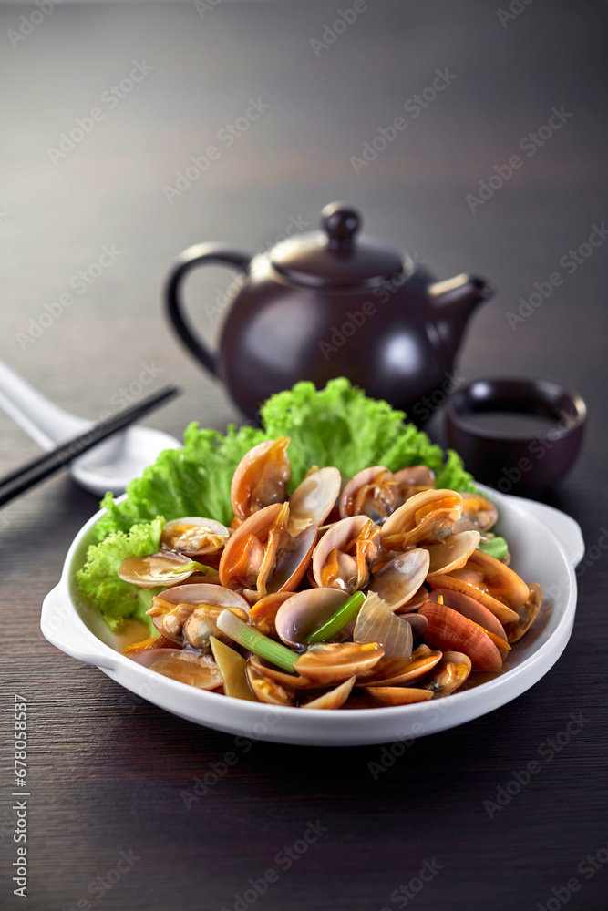 traditional chinese wok fried seafood fresh clam Lala with spicy chilli sauce in plate on grey vintage background asian cafe hotel luxury halal food restaurant banquet menu traditional chinese wok fried seafood fresh clam Lala with spicy chilli sauce in plate on grey vintage background asian cafe hotel luxury halal food restaurant banquet menu