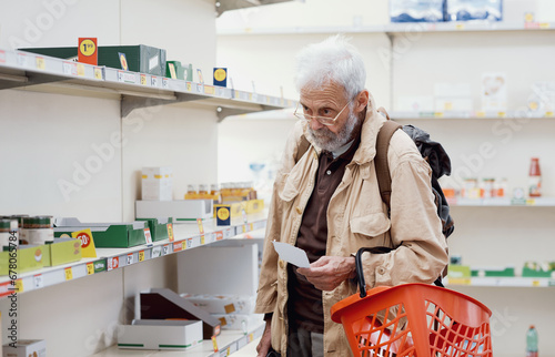 Supermarket with almost empty shelves and senior man looking for goods photo