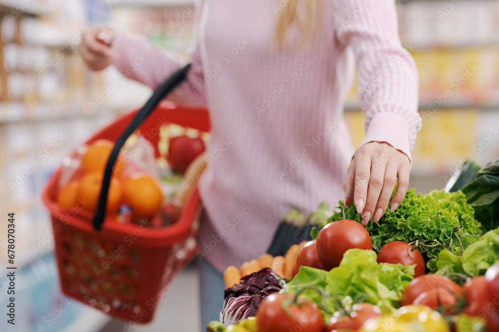 Woman buying fresh vegetables at the grocery store