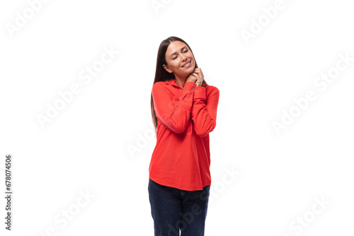portrait of a young successful brunette leader woman dressed in a red blouse on a white background with copy space © Ivan Traimak