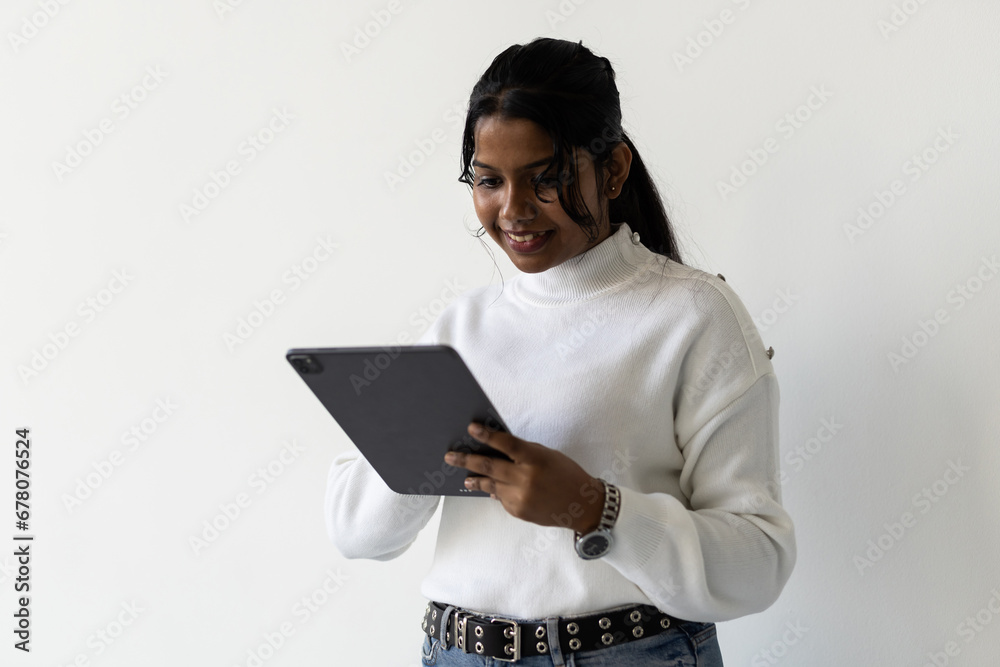 Young Indian woman holding laptop isolated on white background Young Indian woman holding laptop isolated on white background