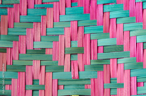 Close up pink and green bamboo basketry woven pattern background. photo