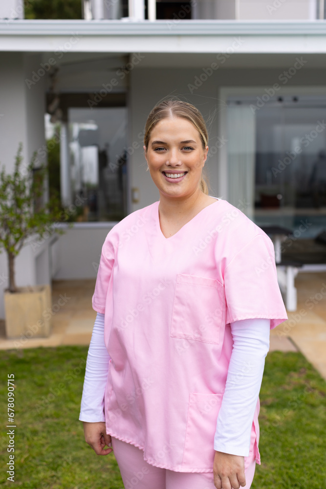 Portrait of caucasian female nurse in garden with copy space Portrait of caucasian female nurse in garden with copy space