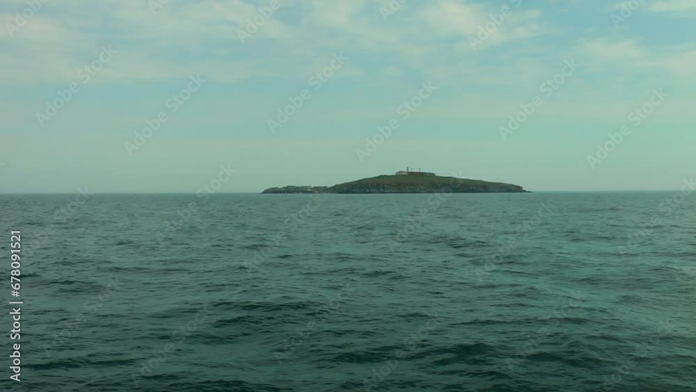 Slow approach to Snake Island on the horizon in cloudy weather. Black Sea, Ukraine. Slow approach to Snake Island on the horizon in cloudy weather. Black Sea, Ukraine.