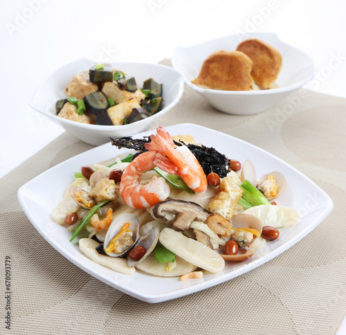traditional chinese set seafood fried putian noodle with dumpling dim sum bao and soup snack vegetable in plate on grey vintage background cafe hotel luxury halal food restaurant banquet menu