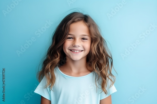 Medium shot portrait photography of a pleased child girl against a light blue background