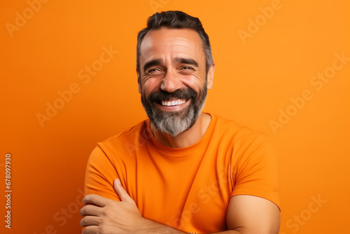 Medium shot portrait photography of a pleased man in his 30s against a light orange background © Nate