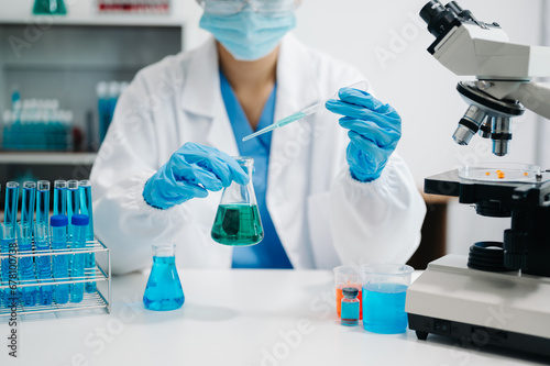 female scientist working with micro pipettes analyzing biochemical samples, advanced science laboratory
