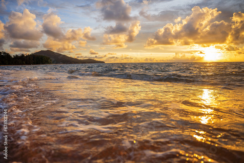 A beautiful wild beach, the waves of the clear sea roll on the white sand. evening sea.
