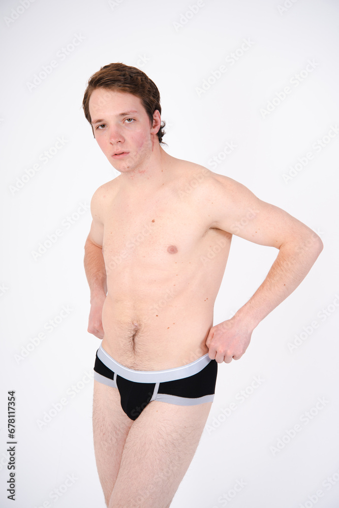 Fototapeta premium A young attractive guy posing in the studio.