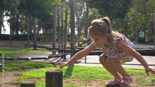 5-year kid girl climbing outdoors on the eco wooden playground