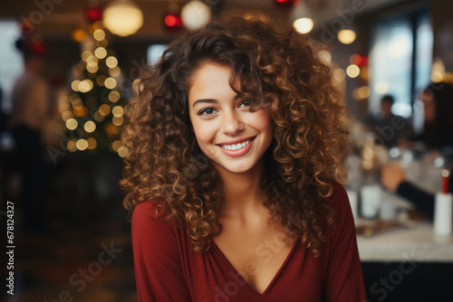 Portrait of a beautiful young woman with curly hair smiling at camera.