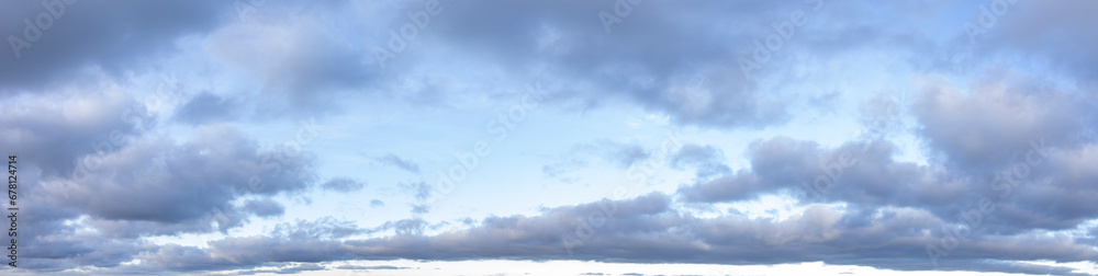 Panoramic cloudscape with blue sky and soft white clouds
