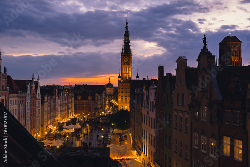 Beautiful old town in Gdansk at summer dusk Poland. Sunset night view from the window rooftop on historical centre Dluga street and city hall architecture buildings St Mary Basilica. Travel attraction