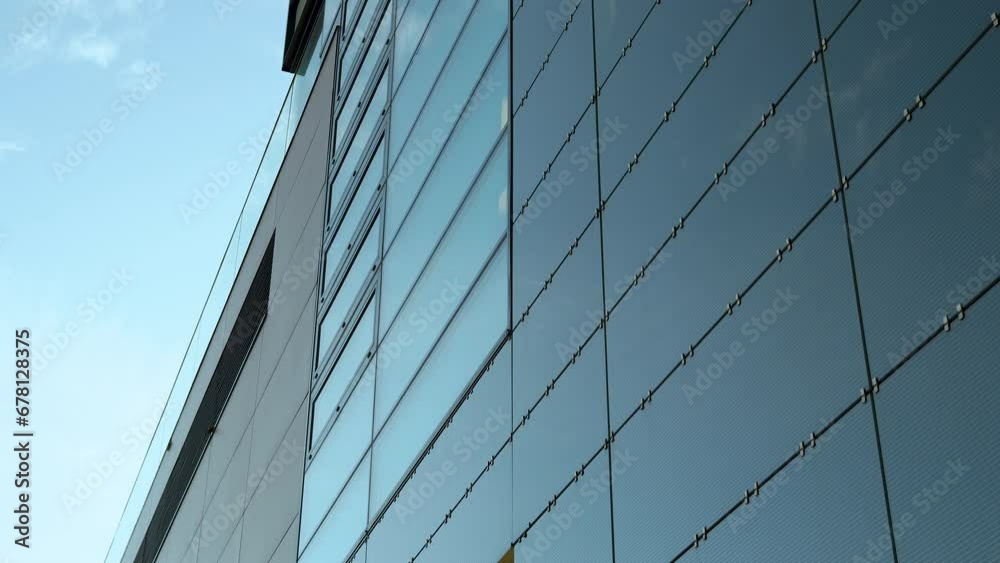 Close-up of modern building's glass facade with steel cables. Close-up of modern building's glass facade with steel cables.