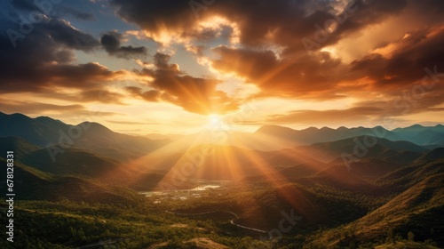 Golden sundown behind the mountains with lots of sun rays in the dramatic sky © shooreeq