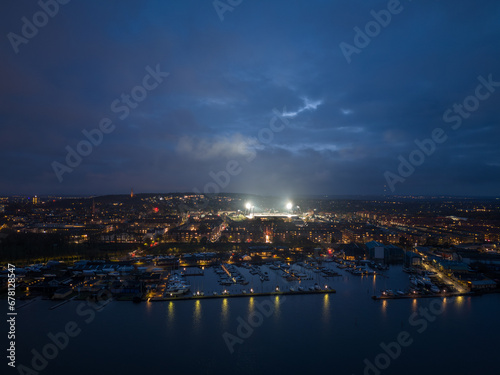 Obraz na płótnie Aerial panoramic night skyline cityscape of Vestbyen city district in Aalborg during football game at the illuminated stadium. North Jutland Region, Denmark. w salonie