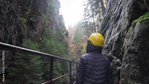 A male traveler walks through a mountain canyon. Active recreation in the mountainous area photo