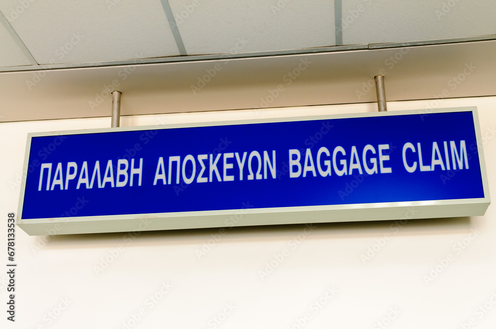 Bilingual sign in a Greek airport for Baggage claim (sic) Bilingual sign in a Greek airport for Baggage claim (sic)
