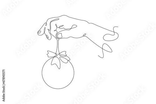 Fototapeta Naklejka Na Ścianę i Meble -  Christmas toy in hand. New Year's tree decoration. Decorating a festive tree. One continuous line drawing. Linear. Hand drawn, white background. One line.