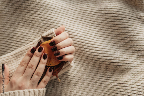 Stylish trendy brown women's nails. Autumn manicure concept. photo