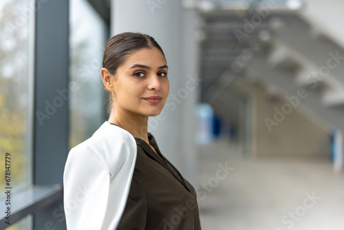 a businesswoman is waiting for someone in an airport corridor