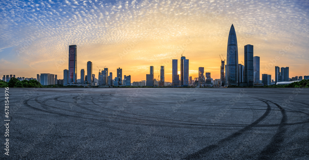 Asphalt road and urban skyline with modern buildings at sunset in Shenzhen, Guangdong Province, China. Road square and skyline background.