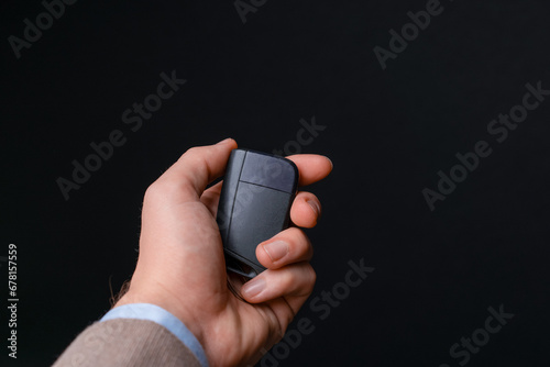 Car sales man handing over car keys for new electric car, to buyer. with black background in studio environment.