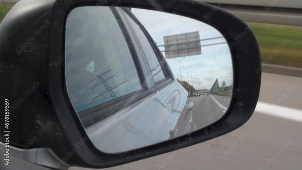 Rear View Mirror View while driving on a highway Rear View Mirror View while driving on a highway